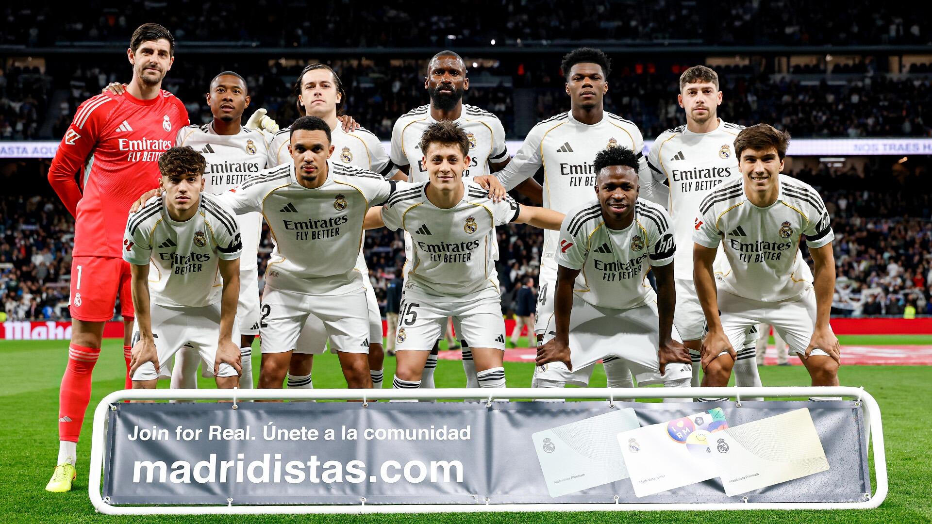 HD PC desktop wallpaper of Real Madrid C.F. soccer team posing in white kits on the pitch with a packed stadium crowd — sports-themed background.