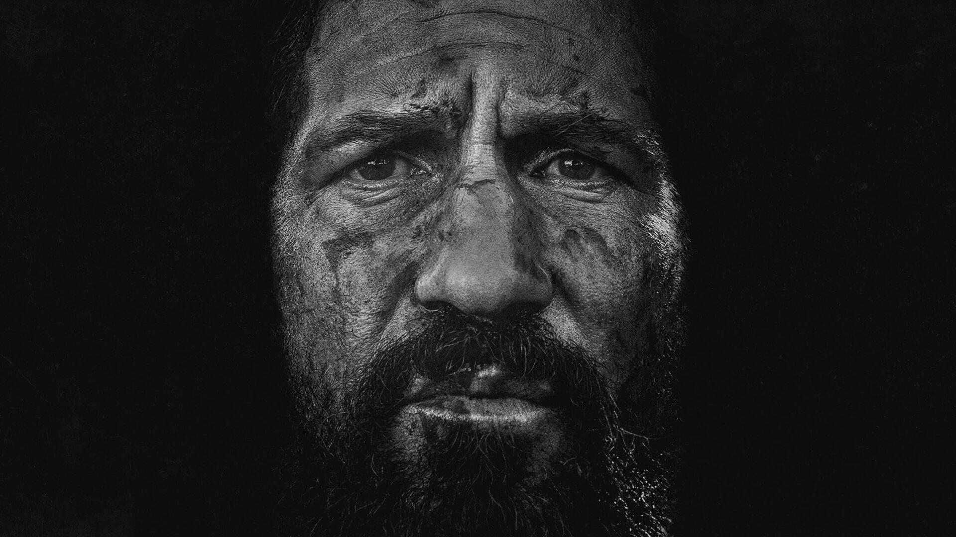 High-contrast black-and-white close-up of a grim, scarred bearded man — The Punisher: One Last Kill. HD PC desktop wallpaper and background.