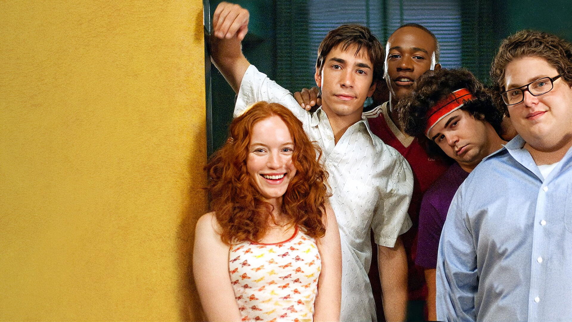 Accepted HD PC desktop wallpaper and background: five young adults clustered in a doorway, warm yellow and teal tones, casual clothing and friendly expressions.