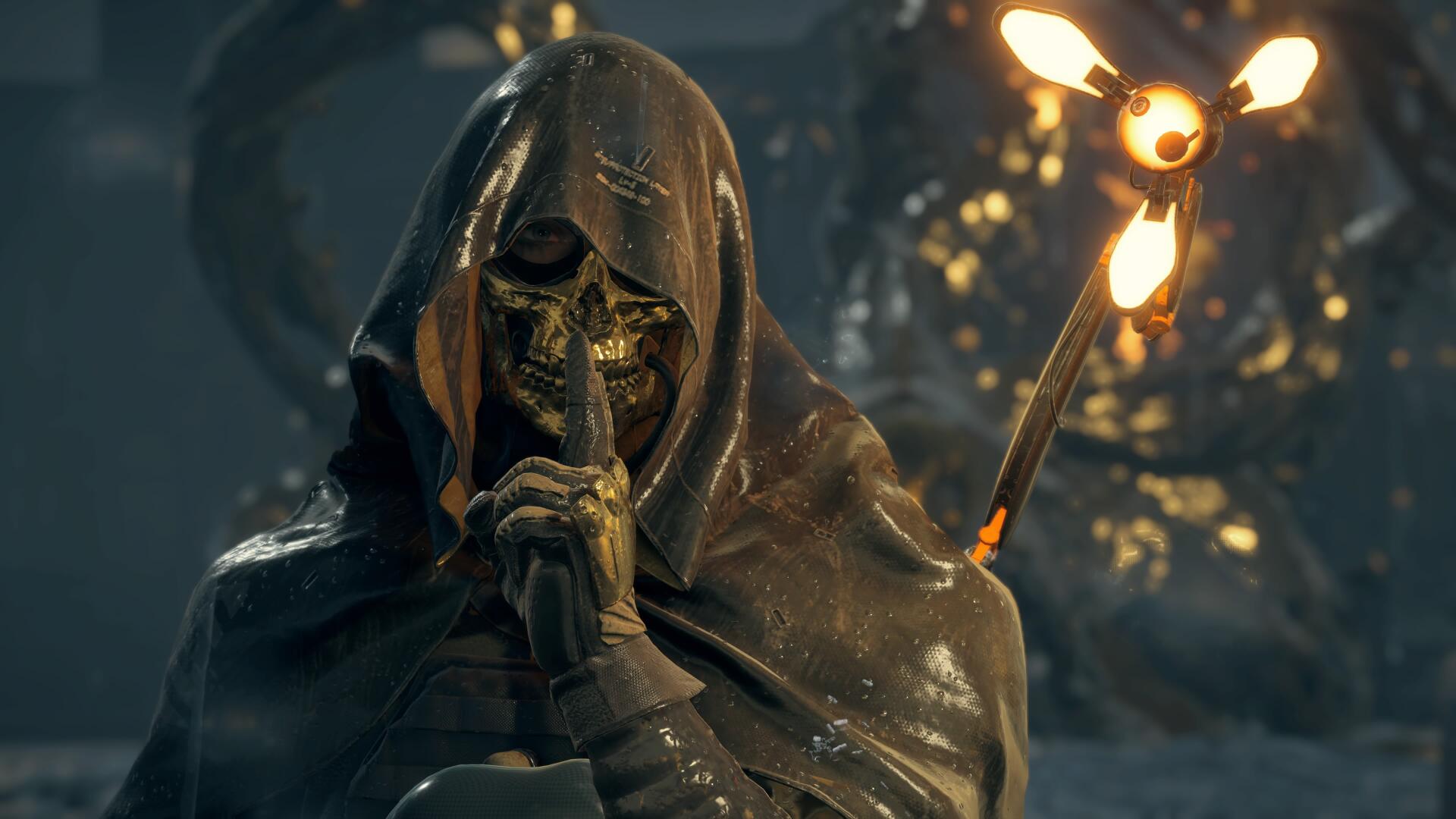 Death Stranding 4K PC wallpaper: hooded skeletal figure shushing with a finger to its lips, rain-soaked cloak and glowing lantern casting eerie light across a dark, atmospheric landscape.