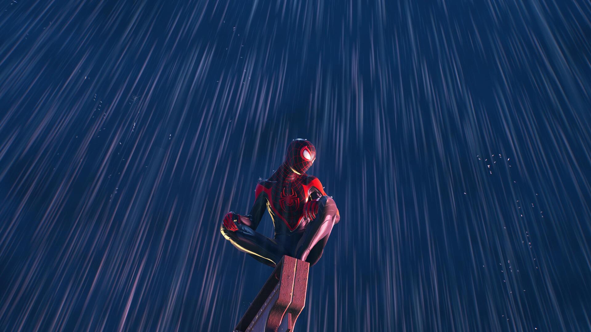 Spider-Man (PS4) in a red-and-black suit crouches on a ledge as rain streaks past in a dramatic low-angle shot — 4K Ultra HD PC desktop wallpaper and background.