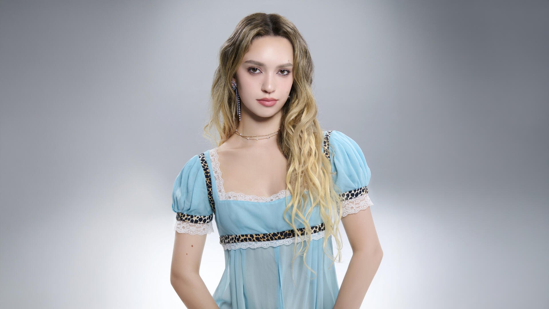 Pop music artist portrait in a pale blue dress for a Katseye-themed 5K Ultra HD PC desktop wallpaper, soft studio lighting and neutral gradient background.