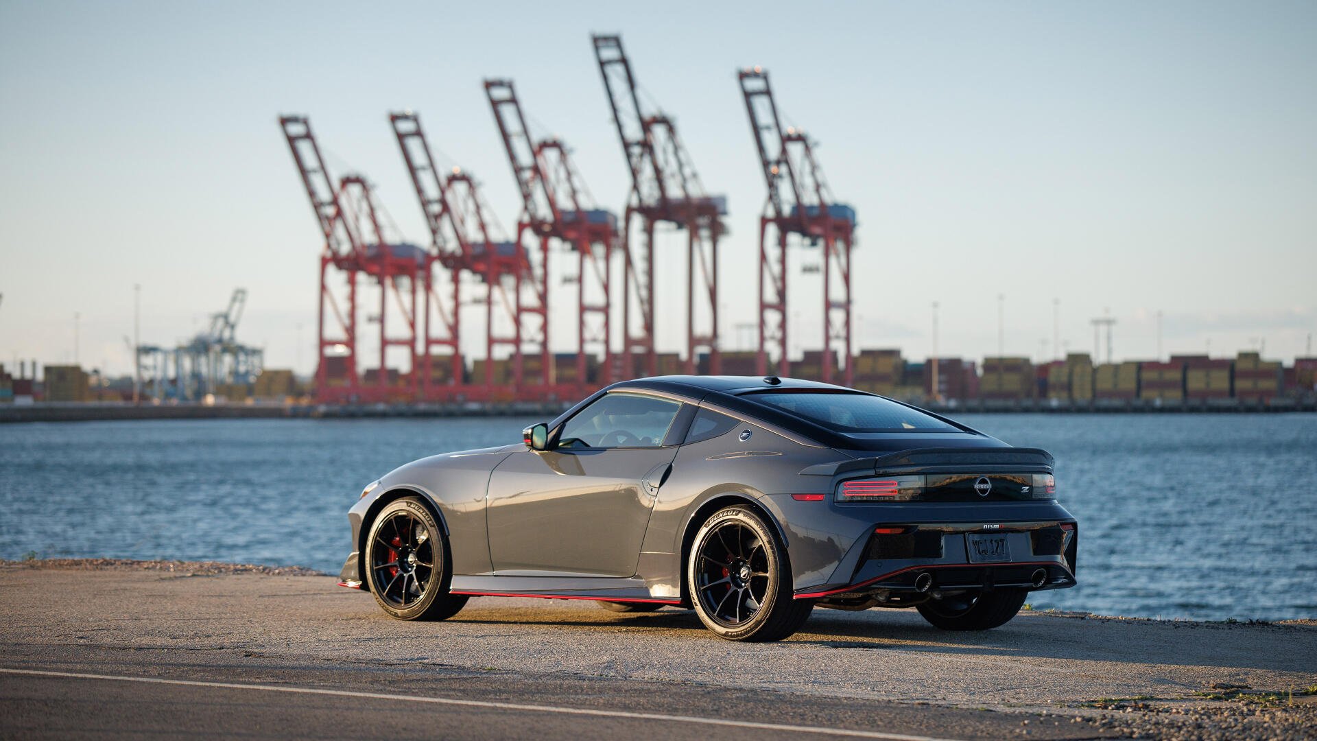 Gray Nissan Z Nismo parked along a waterfront with port cranes in the distance — 4K Ultra HD PC desktop wallpaper/background