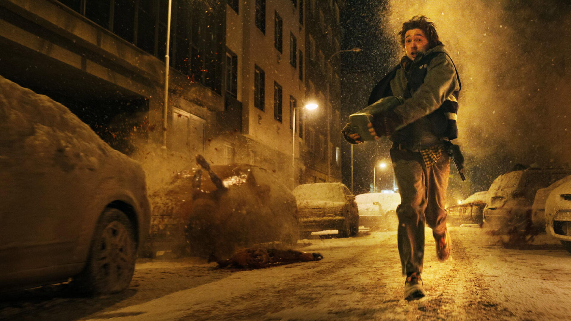 Resident Evil 4K Ultra HD PC desktop wallpaper/background: lone figure flees a snowy, debris-strewn city street as an explosion erupts behind under dim streetlights.