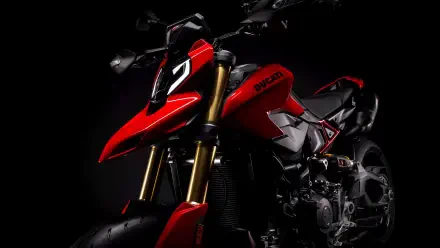 Red Ducati Hypermotard V2 motorcycle in dramatic low-light on black background — 8K Ultra HD PC desktop wallpaper and background.