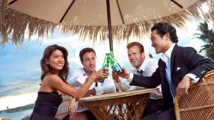 Hawaii Five-0 4K Ultra HD PC wallpaper: four smiling people in evening wear clinking bottles beneath a thatched beach umbrella at an oceanfront table.