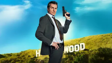 The Naked Gun 4K Ultra HD PC desktop wallpaper and background: man in suit holding a pistol posed before the Hollywood sign on a sunlit hillside under a bright blue sky.