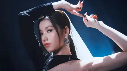 4K Ultra HD portrait wallpaper: female K-pop–inspired performer in a black outfit with long earrings, arms raised in a graceful pose against moody blue backlighting.