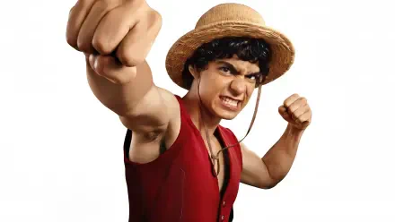 One Piece (Live Action) 4K Ultra HD PC wallpaper: live-action Luffy in straw hat and red vest punches toward the viewer with a fierce grin on a white background.