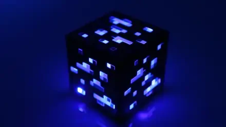 Blue-glowing Minecraft ore block casting neon light on a dark backdrop — 4K Ultra HD PC desktop video game wallpaper.