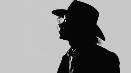 Shadow silhouette of a fedora-wearing male musician in profile on a gray background, 2K Quad HD PC desktop wallpaper.