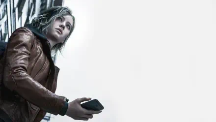 Grace Ashcroft from Resident Evil Requiem, in a leather jacket holding a device against a white 2K Quad HD PC desktop wallpaper background.