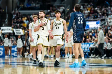 NCAA: Purdue Boilermakers players in white uniforms on court during a game — HD PC desktop wallpaper/background with arena crowd