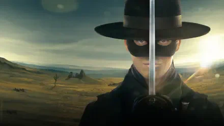 Zorro in black hat and mask holds a drawn sword vertically, sunlight glinting on the blade over a windswept plain — 4K Ultra HD PC desktop wallpaper/background.