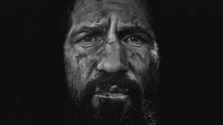 High-contrast black-and-white close-up of a grim, scarred bearded man — The Punisher: One Last Kill. HD PC desktop wallpaper and background.