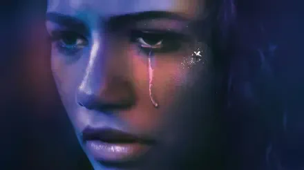 Close-up of a tearful young woman in a moody Euphoria TV-show style, sad and crying; HD PC desktop wallpaper background.