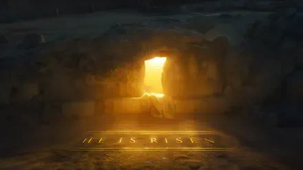 2K Quad HD desktop wallpaper: empty tomb with stone rolled away, golden light pouring through the entrance and HE IS RISEN glowing on the floor, evoking Jesus' resurrection.