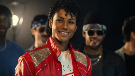 4K Ultra HD PC desktop wallpaper for the movie Michael (2026): smiling performer in a red jacket beneath stage lights, flanked by bandmates.