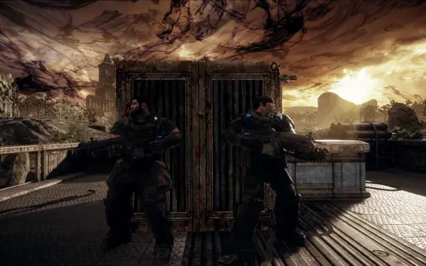 Gears Of War: Reloaded video game — two armored soldiers back-to-back behind a metal barricade on a ruined rooftop at sunset. 4K Ultra HD PC desktop wallpaper.