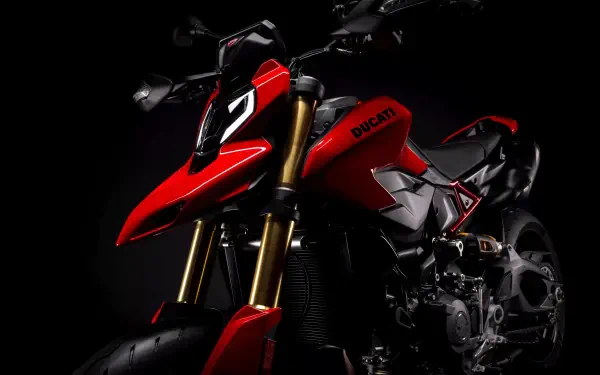Red Ducati Hypermotard V2 motorcycle in dramatic low-light on black background — 8K Ultra HD PC desktop wallpaper and background.