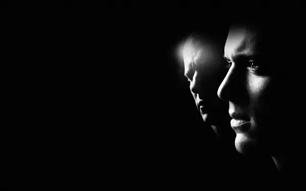 Prison Break 4K Ultra HD PC desktop wallpaper: stark black-and-white profiles of two faces emerging from deep shadow, cinematic and tense atmosphere.