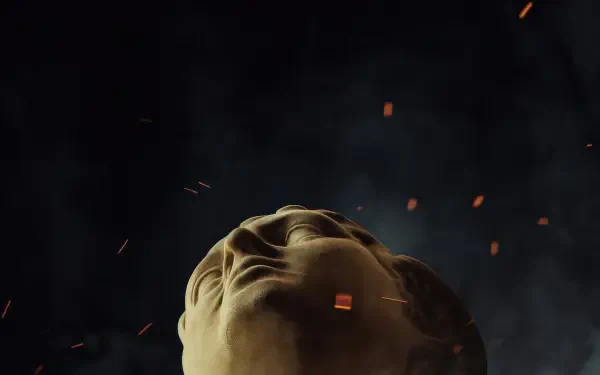 Low-angle close-up of a classical marble head amid drifting embers and a dark smoky sky — The Odissey 4K Ultra HD PC desktop wallpaper and background.