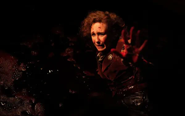 The Conjuring: Last Rites 4K Ultra HD PC desktop wallpaper and background — shadowed, terrified figure reaching out of blood-red darkness, textured grain and eerie lighting.