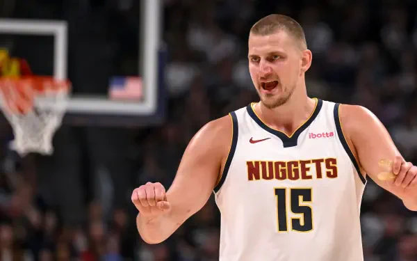 HD PC desktop wallpaper of an NBA basketball player in a Denver Nuggets No. 15 jersey on the court.