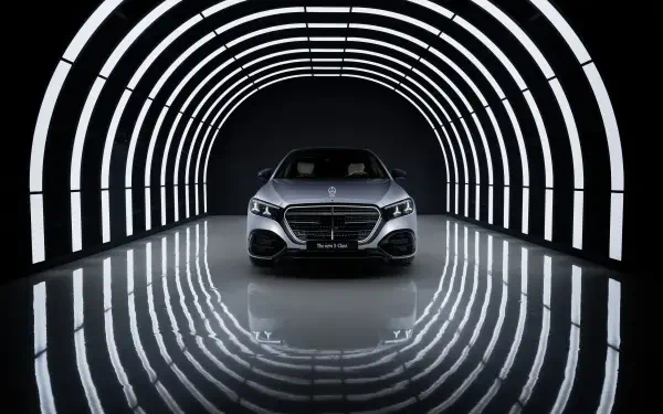 Gray Mercedes-Benz S 580 vehicle centered in an illuminated tunnel with reflective floor; high-resolution 5K Ultra HD desktop wallpaper background.