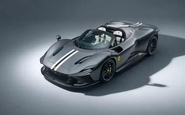 Black Ferrari Daytona SP3 with white racing stripe, three-quarter studio view on gray backdrop — 8K Ultra HD PC desktop wallpaper/background.