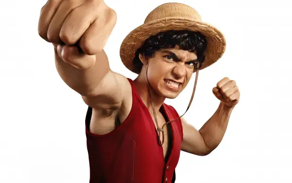 One Piece (Live Action) 4K Ultra HD PC wallpaper: live-action Luffy in straw hat and red vest punches toward the viewer with a fierce grin on a white background.