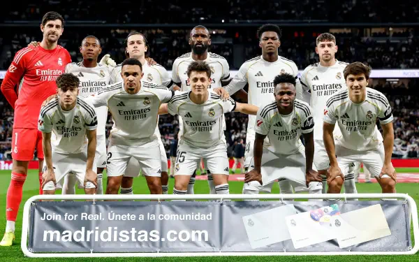 HD PC desktop wallpaper of Real Madrid C.F. soccer team posing in white kits on the pitch with a packed stadium crowd — sports-themed background.