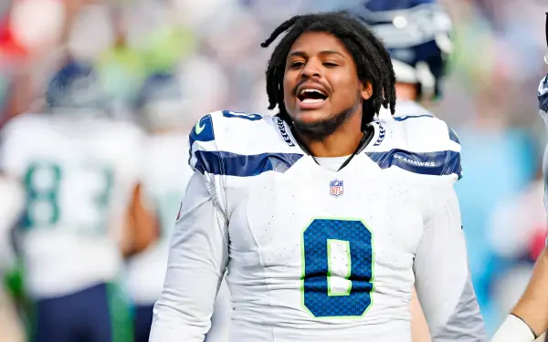 High-res 2K Quad HD PC wallpaper: an NFL player in a Seattle Seahawks white jersey (#0) celebrating on the field.