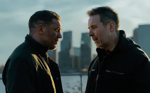 Two men facing off by a river with a muted skyline — MobLand TV show 4K Ultra HD PC desktop wallpaper.