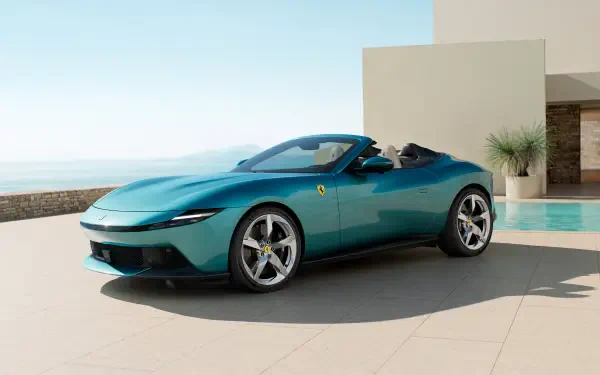 Teal Ferrari Amalfi Spider car convertible parked on a sunlit modern terrace by a pool and sea, 4K Ultra HD PC desktop wallpaper.