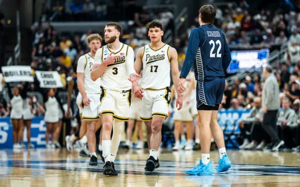 NCAA: Purdue Boilermakers players in white uniforms on court during a game — HD PC desktop wallpaper/background with arena crowd