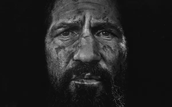 High-contrast black-and-white close-up of a grim, scarred bearded man — The Punisher: One Last Kill. HD PC desktop wallpaper and background.