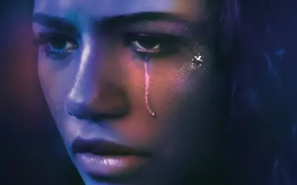 Close-up of a tearful young woman in a moody Euphoria TV-show style, sad and crying; HD PC desktop wallpaper background.