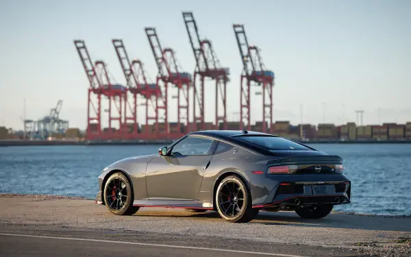 Gray Nissan Z Nismo parked along a waterfront with port cranes in the distance — 4K Ultra HD PC desktop wallpaper/background