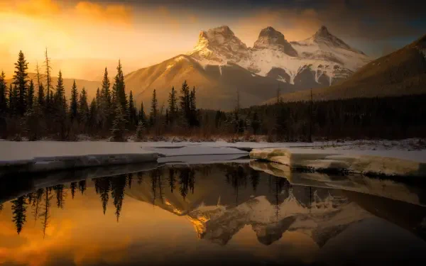 5K Ultra HD PC desktop wallpaper: Golden Hour mountain peaks and pine silhouettes reflected in a glassy alpine lake, snow-capped ridges in a dramatic nature landscape.
