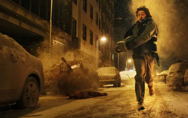 Resident Evil 4K Ultra HD PC desktop wallpaper/background: lone figure flees a snowy, debris-strewn city street as an explosion erupts behind under dim streetlights.