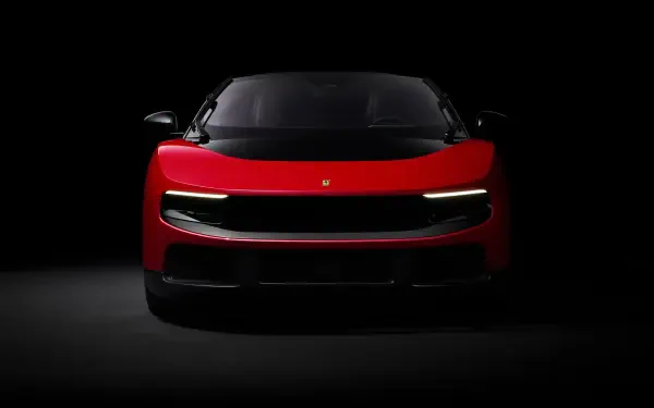 Red Ferrari Luce sports vehicle, front view in dramatic low-key lighting — 4K Ultra HD PC desktop wallpaper/background.