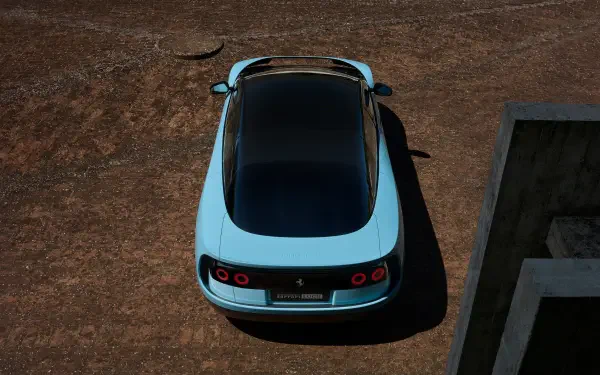Top-down view of a pale blue Ferrari Luce on cracked earth, presented as a 4K Ultra HD PC desktop wallpaper and background.
