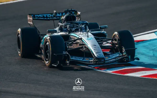 F1 Mercedes-AMG Grand Prix car cornering on track, high-detail 2K Quad HD PC desktop wallpaper and background with Mercedes‑Benz logo at the bottom.