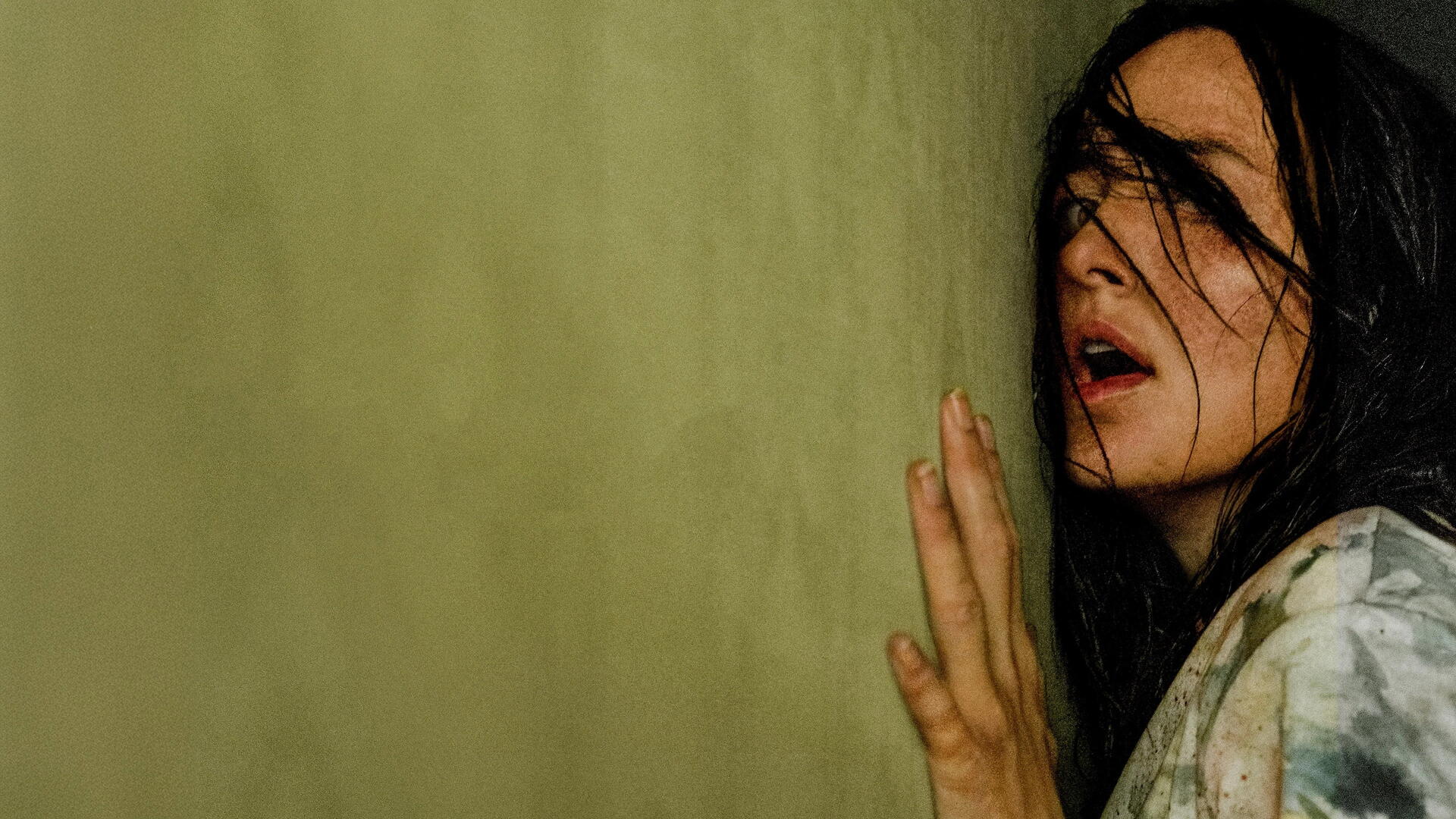 Backrooms 4K Ultra HD PC desktop wallpaper and background: woman with wet dark hair pressed to a grimy yellow wall, hand splayed, eyes wide in a dim, claustrophobic corridor.