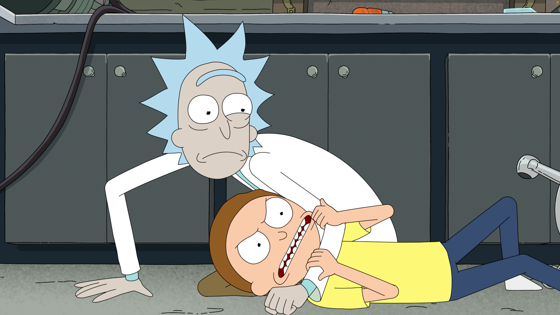 TV show Rick and Morty season 9 HD PC desktop wallpaper/background: Rick pins a struggling Morty to a lab floor, holding his face while Morty grimaces.