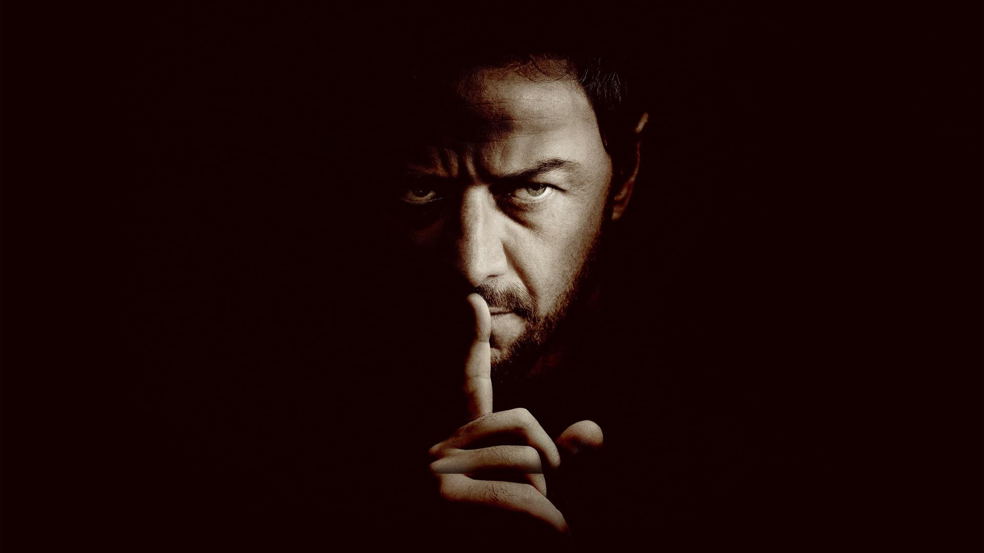 Speak No Evil - 4K Ultra HD PC desktop wallpaper: shadowed man pressing a finger to his lips against a near-black background.
