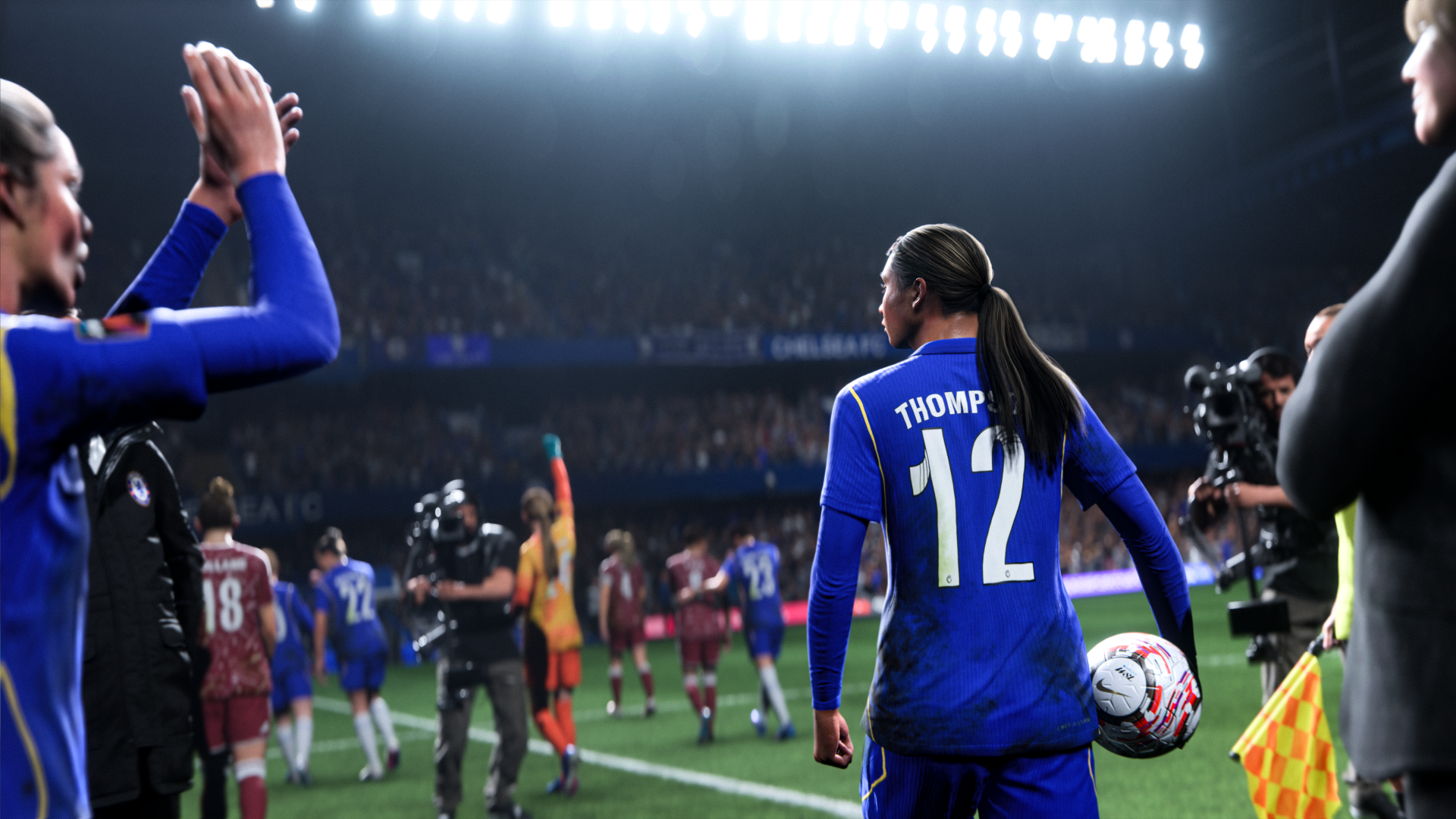 4K Ultra HD PC desktop wallpaper: EA SPORTS FC 27 scene of a soccer player wearing #12 walking across a floodlit stadium pitch as cameras and teammates follow.
