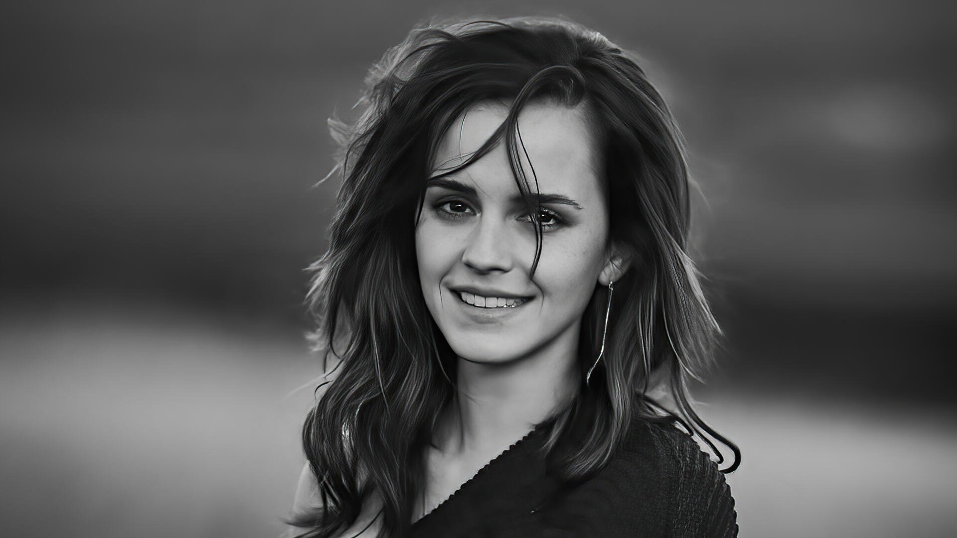 Black-and-white headshot of a smiling young woman with windblown hair against a soft backdrop — 5K Ultra HD PC desktop wallpaper and background.