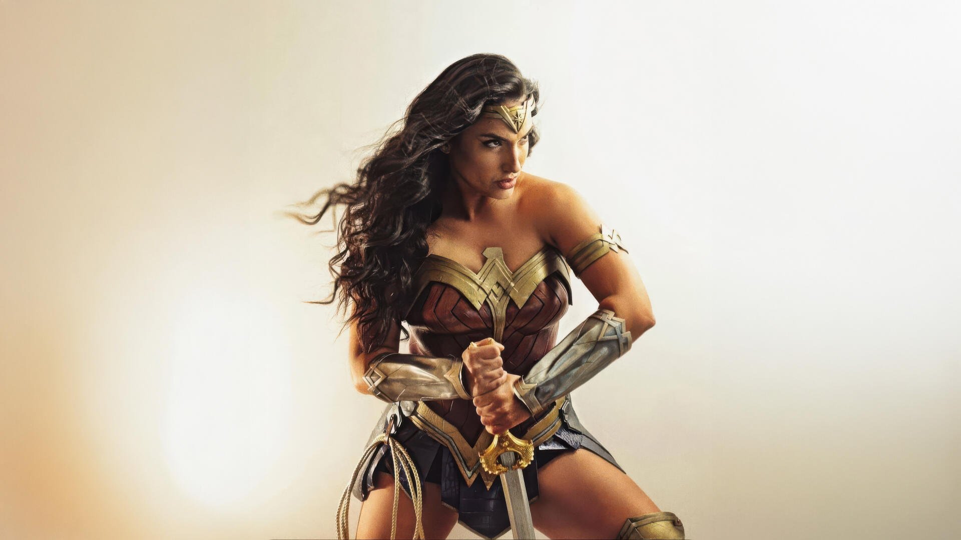 Wonder Woman superhero cosplay: armored heroine holding a sword in a dramatic pose — 5K Ultra HD PC desktop wallpaper/background.